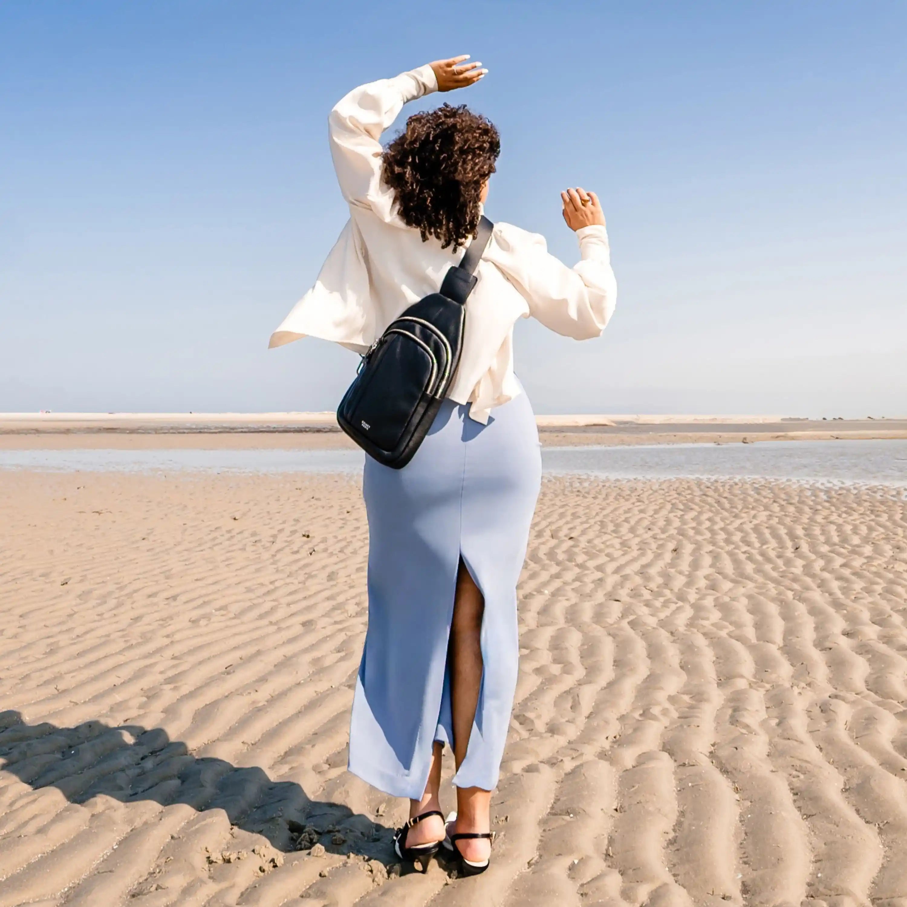 Black leather sling bag — compact travel crossbody for long trips